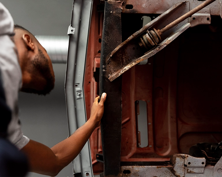 Mechanic inspecting a car door frame