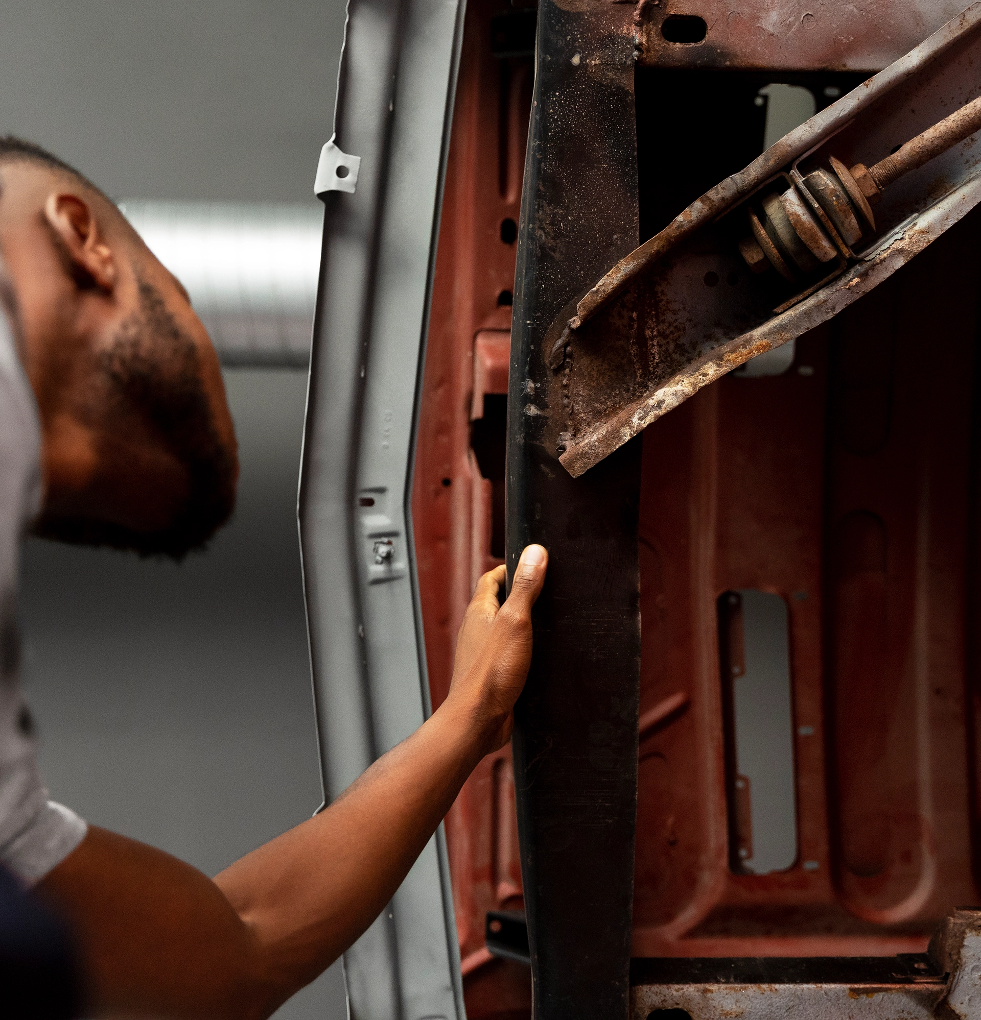 Mechanic inspecting a car door frame